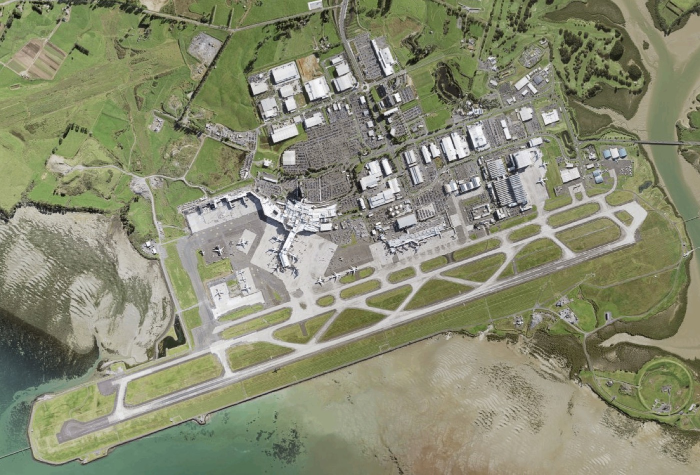 Aerial view of Auckland Airport and the surrounding Māngere area.