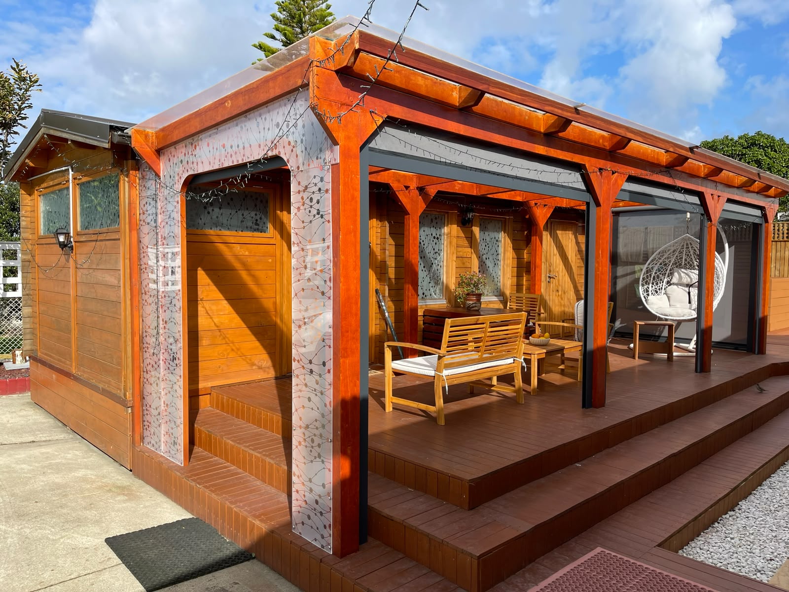 Auckland Airport Cabin, a private cabin with a covered deck and hanging egg chair, in Māngere.
